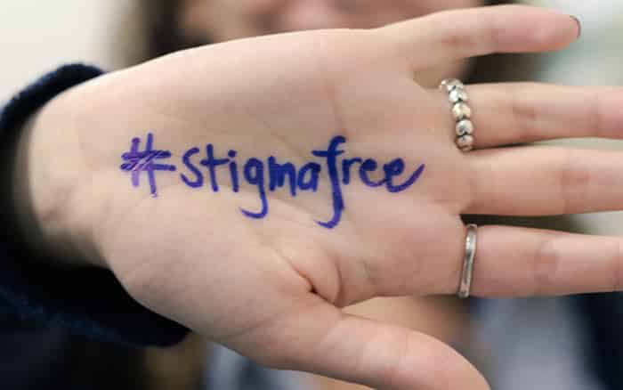 NAMI hashtag stigmafree written in permanent ink on a palm facing the camera